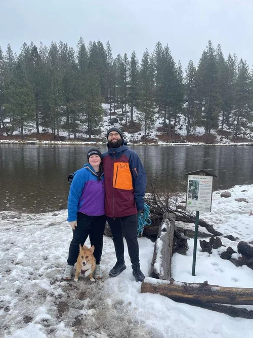 Dr. Sabrina with her partner and corgi by a snowy lake in the Pacific Northwest